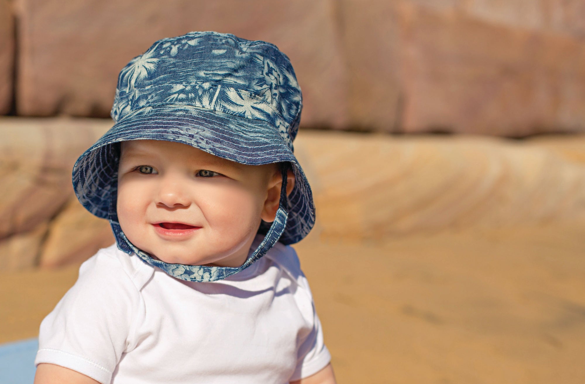 Child Wearing an adventure bucket Aloha sun hat with Chinstrap in Denim