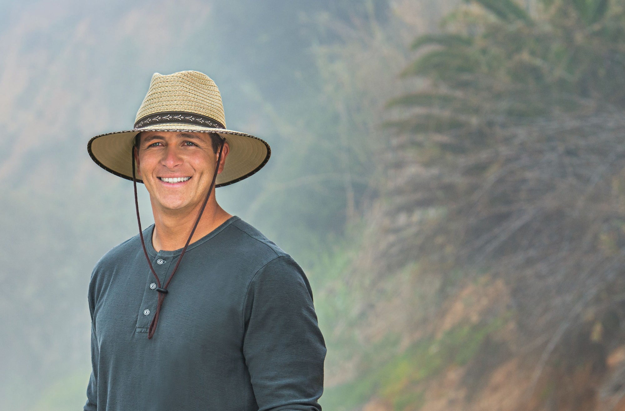 Man Smiling and Wearing a Wallaroo Cabo Beach Sun Hat with Chinstrap