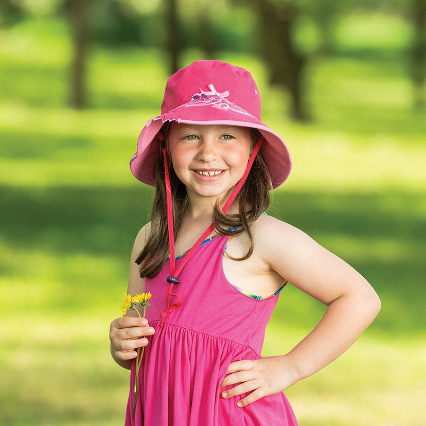 Girl Wearing a Wallaroo Crocodile Cotton Sun Hat with Chinstrap while Holding a Flower