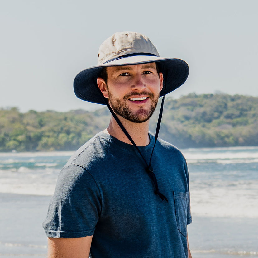 Man Wearing a Wallaroo Explorer Summer Bucket Hat on a Beach