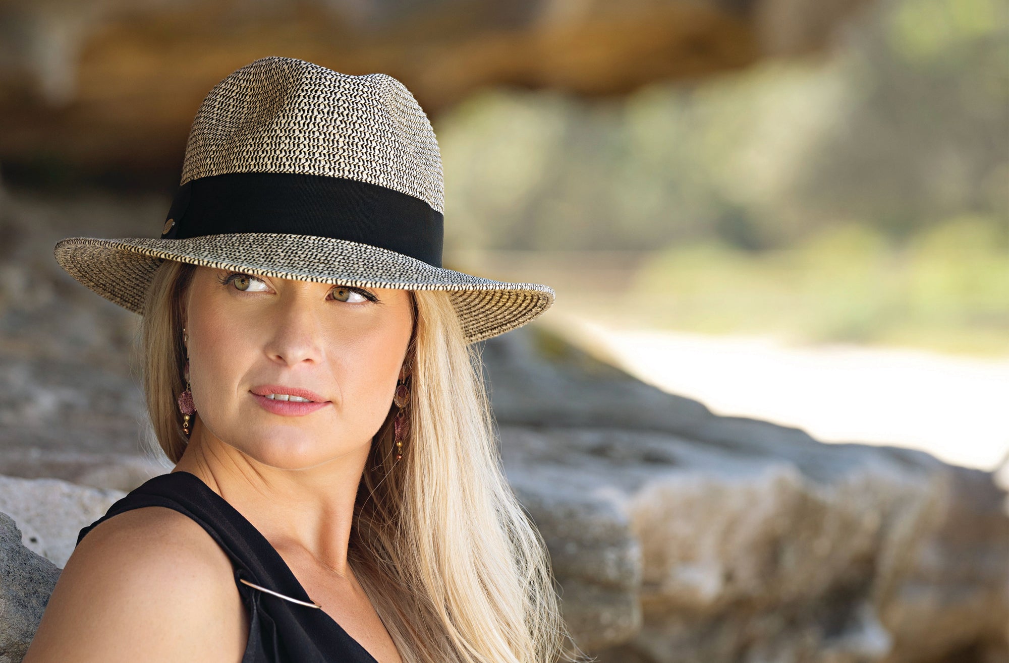 Woman wearing the stylish Josie Summer cap for ladies designed for travel