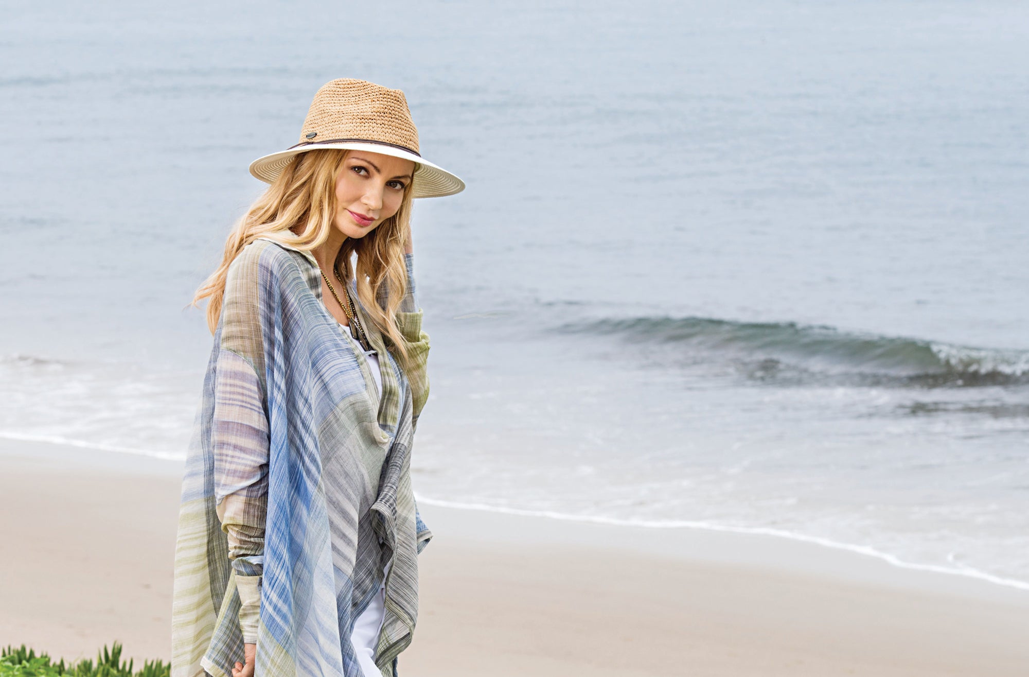 Woman Wearing a Wallaroo Laguna Straw Summer Hat on a Beach