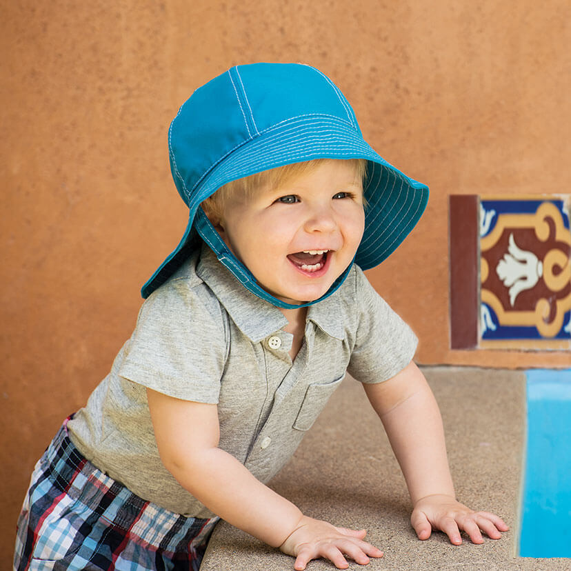 Laughing Boy Wearing a Wallaroo Microfiber Platypus Microfiber Sun Hat with Chinstrap