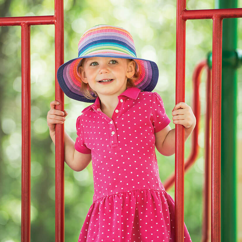 Girl Wearing a Wallaroo Petite Nantucket Polyribbon Sun Hat on a Slide