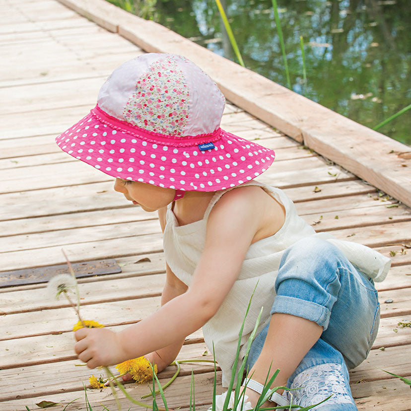 Child Picking Flowers Wearing a Wallaroo Platypus Cotton Sun Hat with Chinstrap