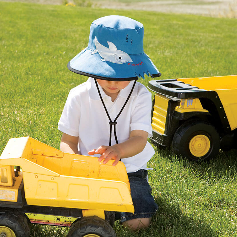 Boy Wearing a Wallaroo Shark Hat Cotton Sun Hat with Chinstrap while Playing with a Toy