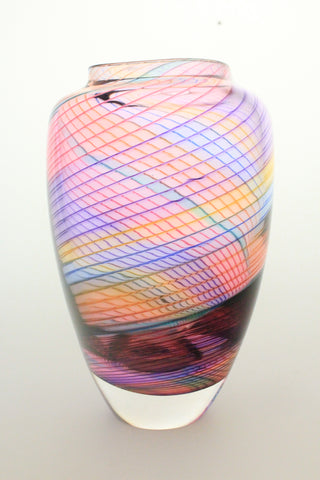 Glass vase with ribbed overlay featuring the beautiful aurora color varient.