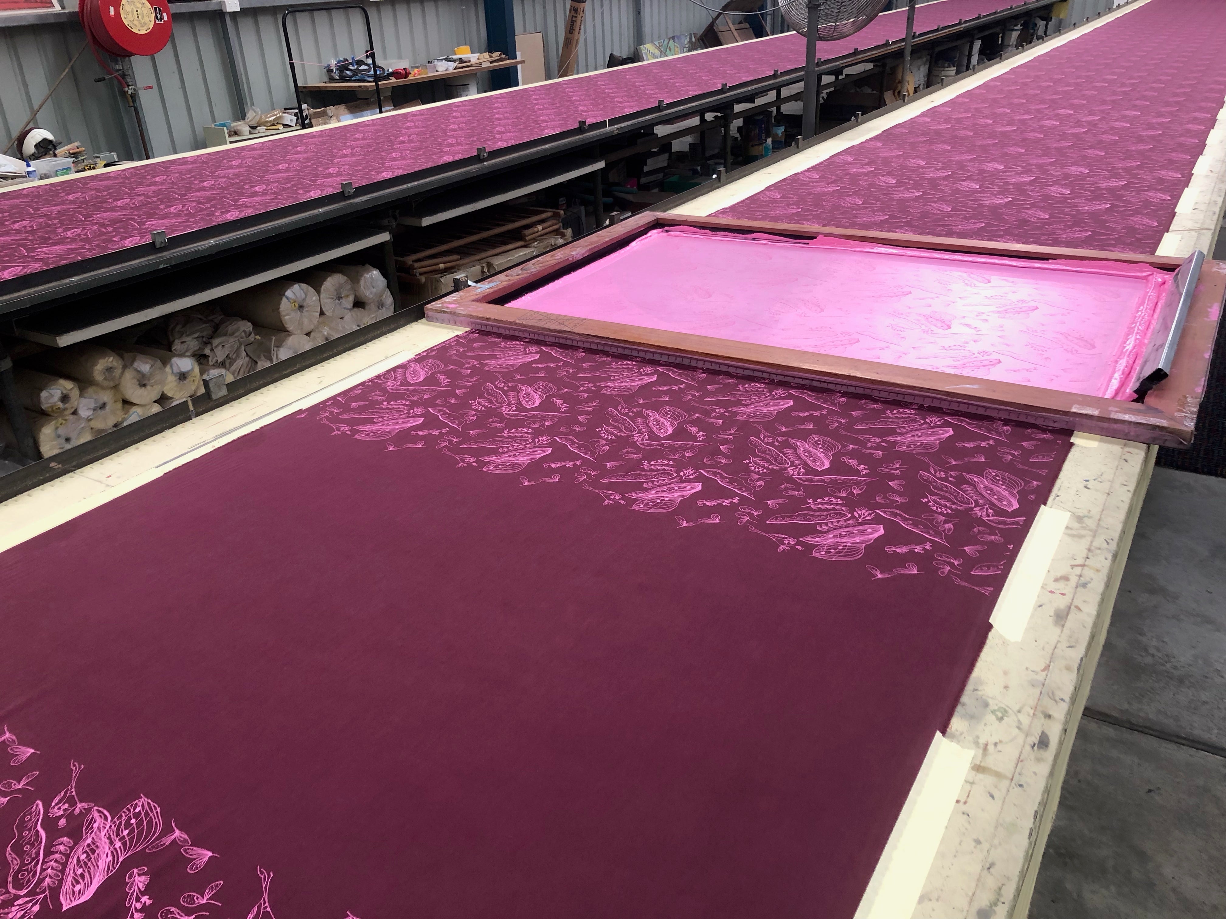 Fabric in the process of being screen printed at a production facility