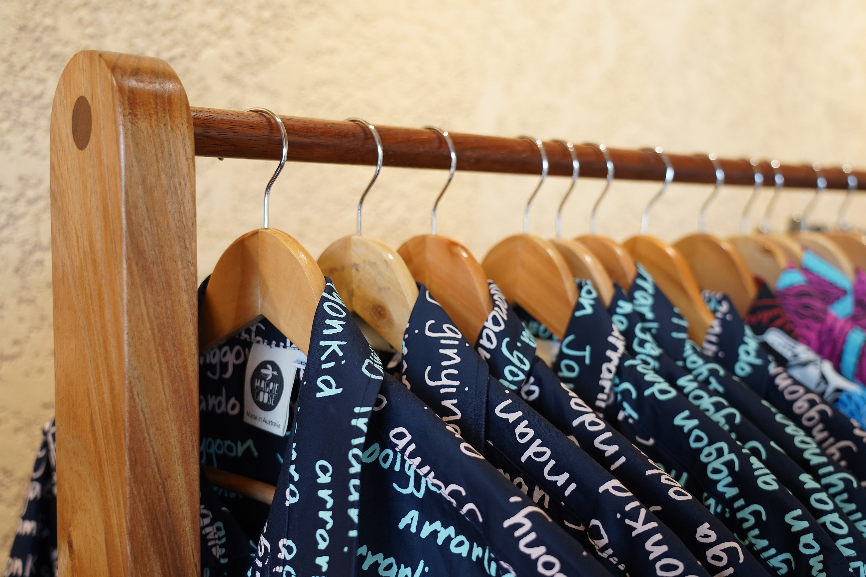 Magpie Goose garments hanging on a custom-built rack in the flagship store