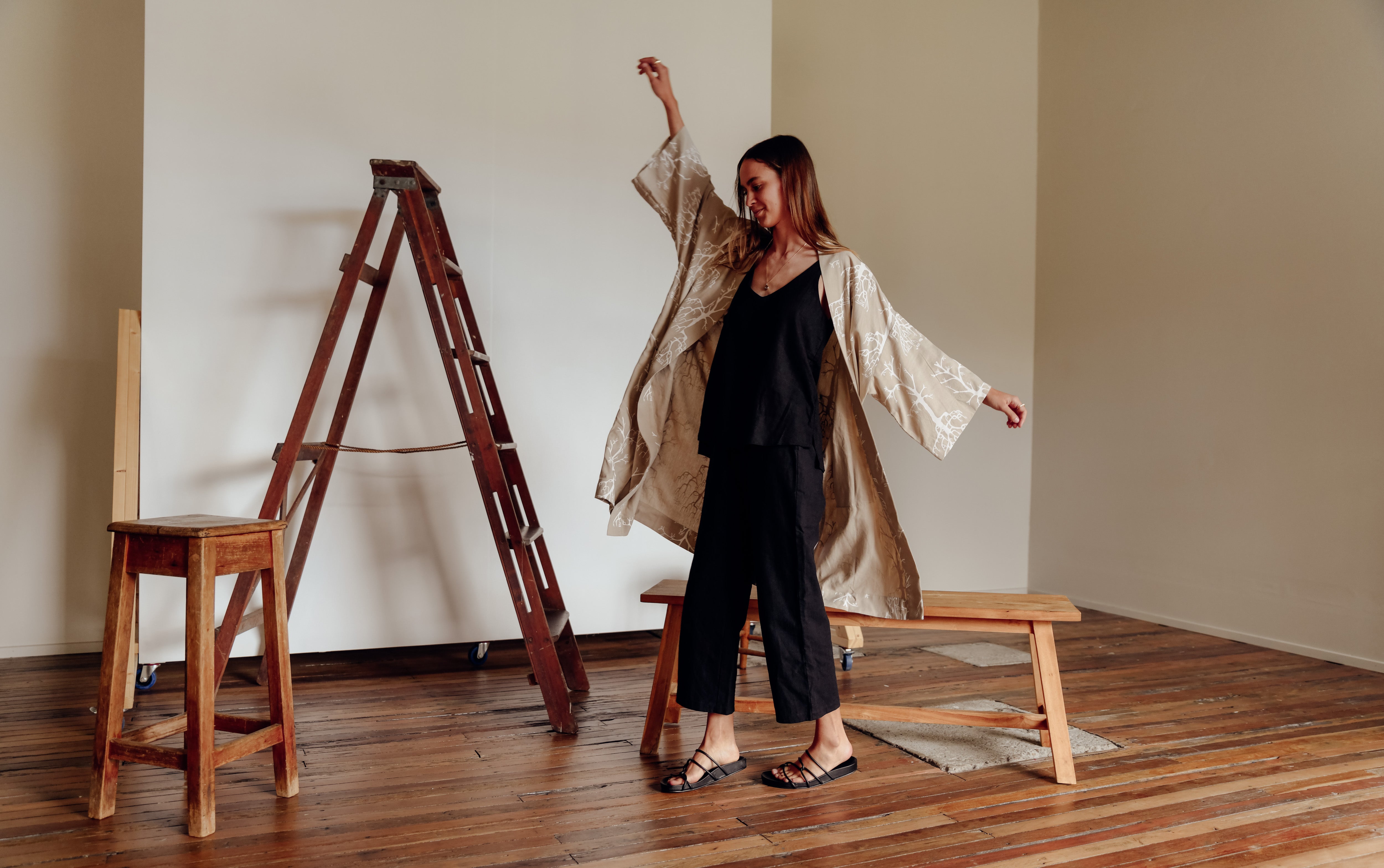 Model dancing in a studio in her linen robe