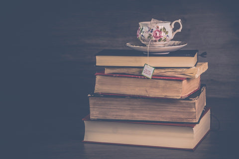 teapot standing on a stack of old antique books