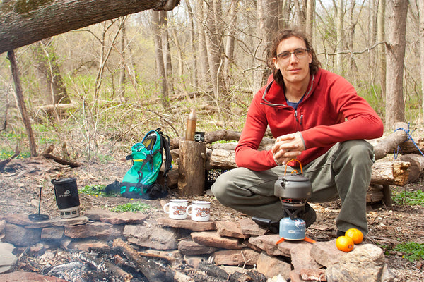 Trevor smiles by campfire