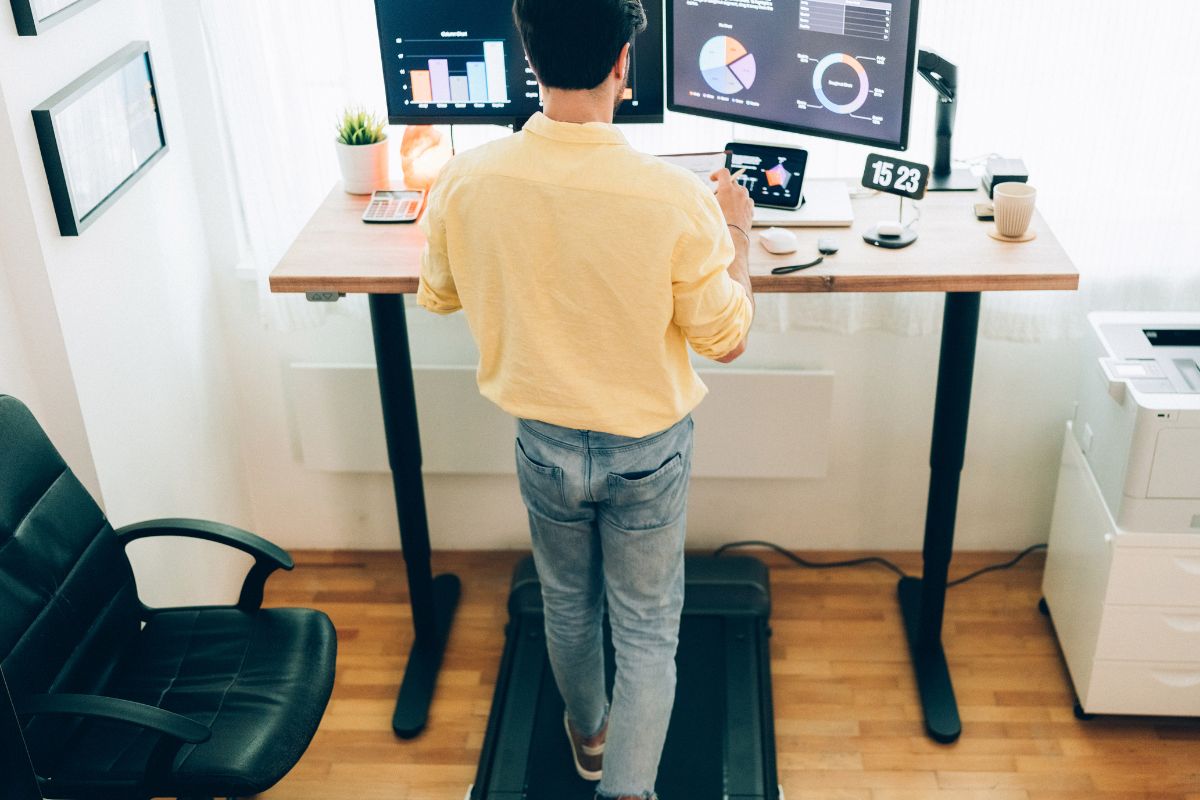 Man using under-desk treadmill.
