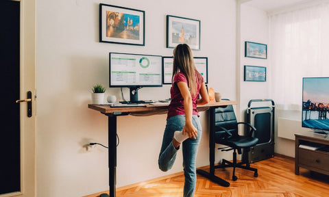 Woman stretching at her standing desk.