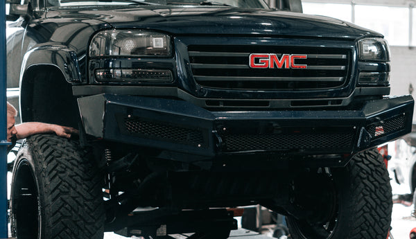 Second Generation GMC on Lift Assessing Wheel Fitment