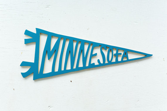 Minnesota Baseball pennant in a variety of colors. Handmade in Minnesota, handpainted and perfect for your favorite sports fan or Minnesotan. Carver Junk Company stores or online at carverjunkcompany.com. $35 Each one will vary slightly. 2016 Holiday Gift Guide 