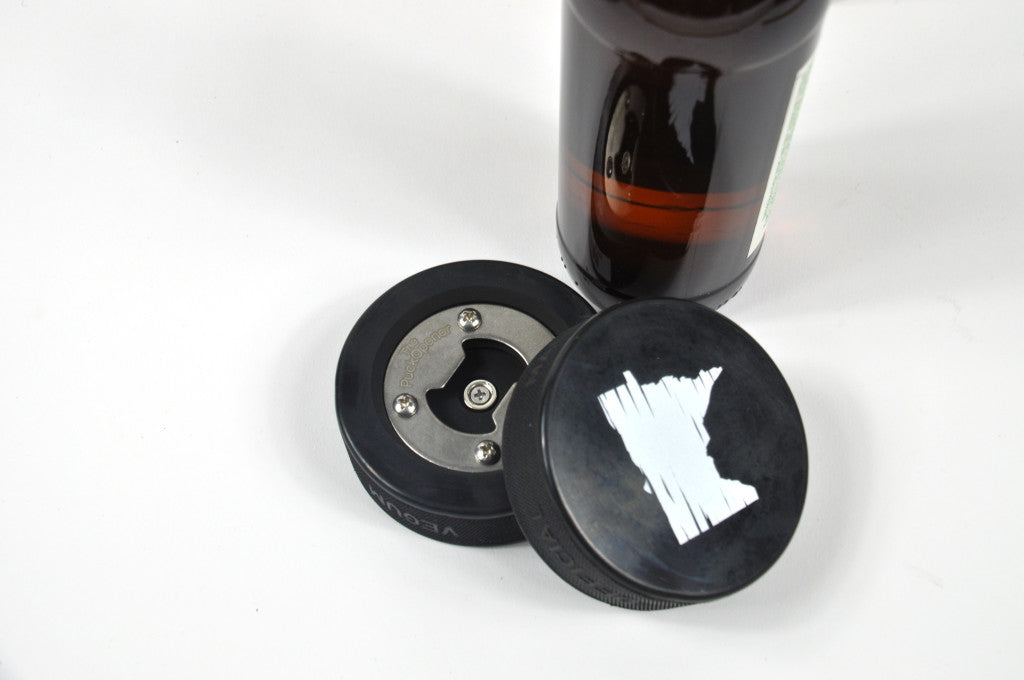 Hockey Puck Bottle Opener, made with a real hockey puck. Distressed Minnesota design, and the opener is inset, so puck can be used for a real game! Holiday 2016 gift guide.