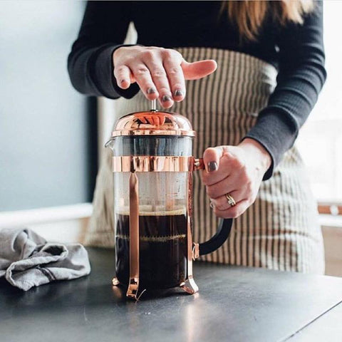 Making cold brew coffee with milk in a french press, also known as a  cafetière, coffee press, or coffee plunger Stock Photo