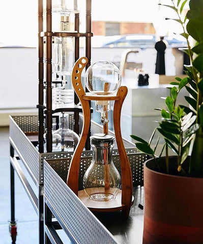 cold coffee drip beside a plant pot