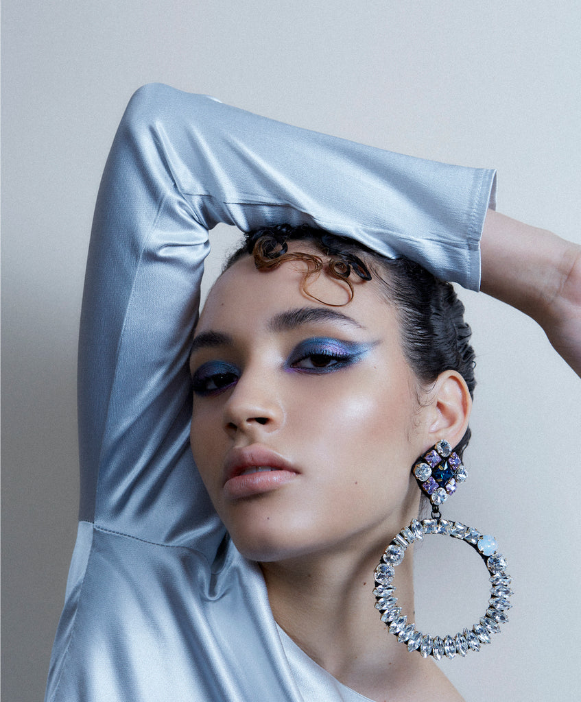 A model wearing Jolita Jewellery's crystal hoops statement earrings