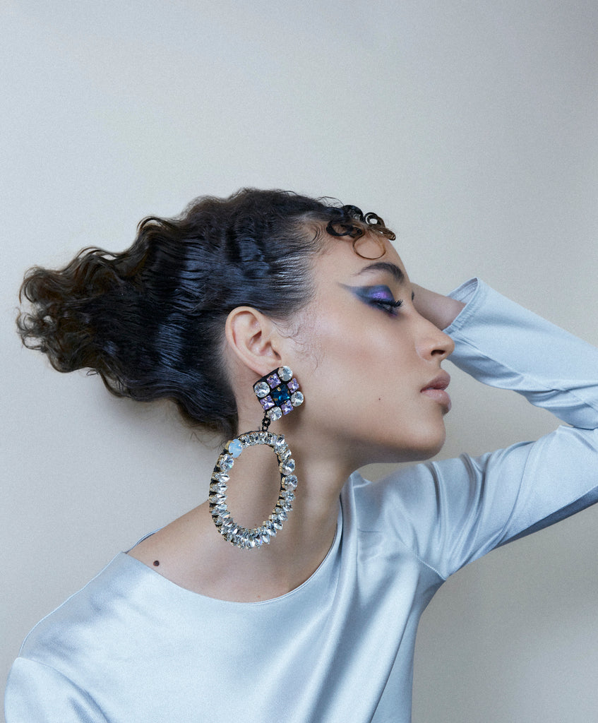 A model wearing Jolita Jewellery's crystal hoops statement earrings