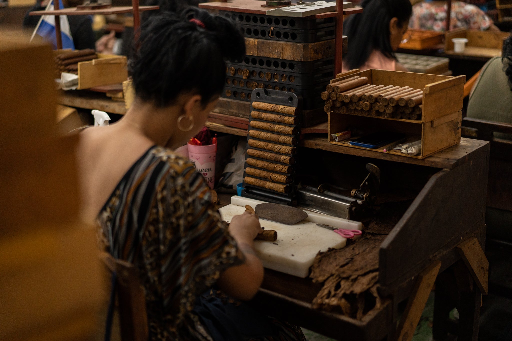 Cigar rolling and pressing in action.