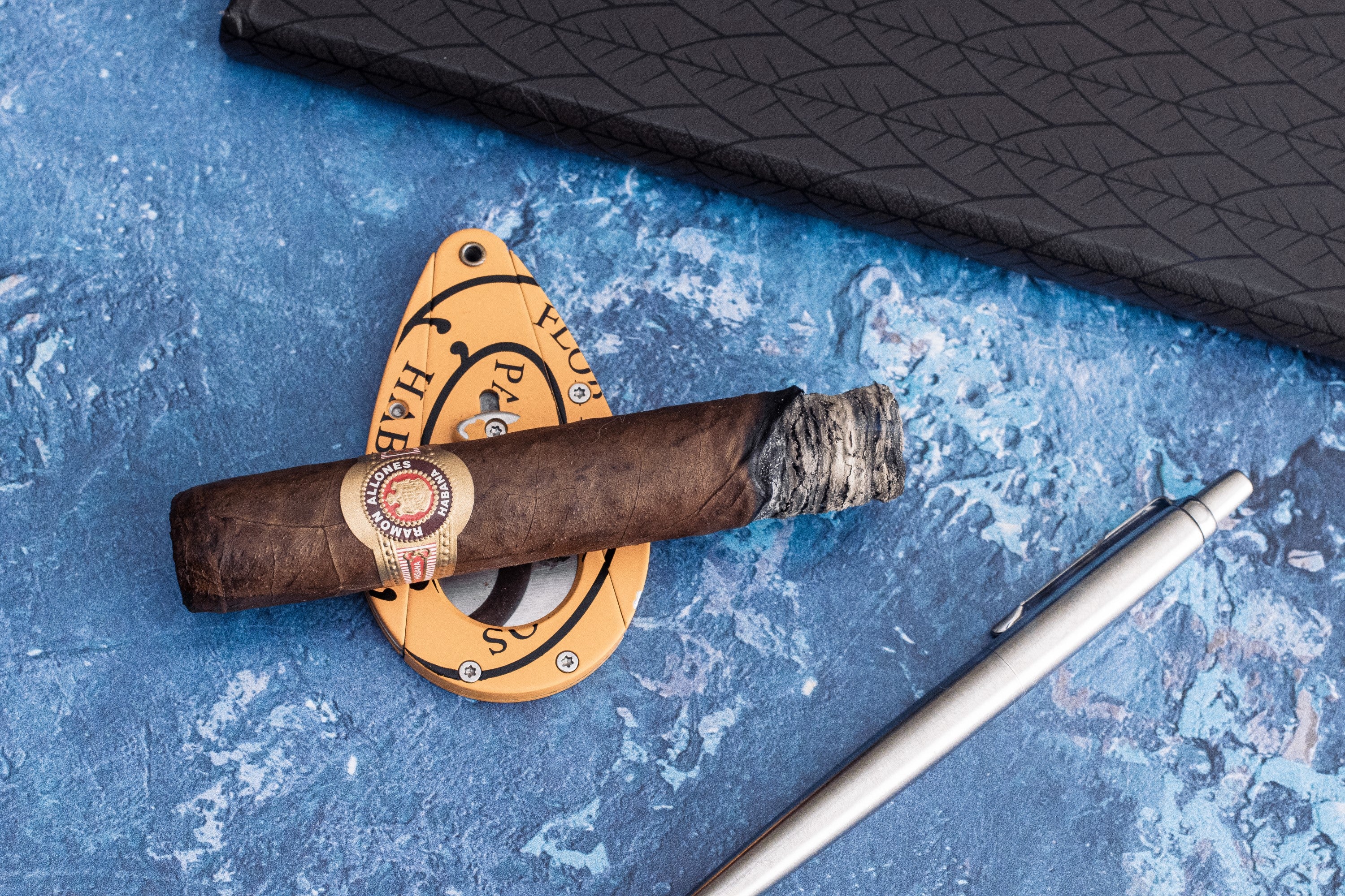 A smouldering Ramon Allones Specially Selected Cuban Cigar in the middle third