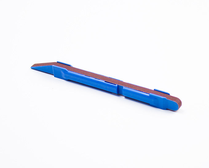 a blue sanding stick against a white background