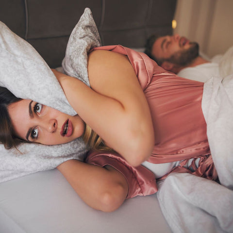 Image of a girl with her snoring husband