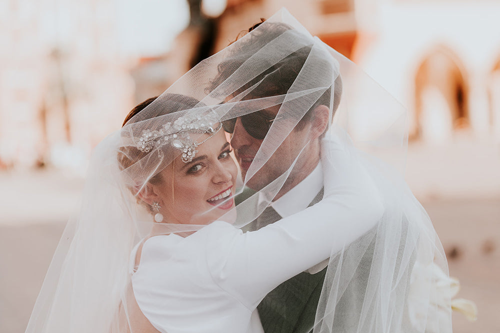 Wedding photoshoot of smiling bride with groom faced toward bride | Fine jeweller Fenton