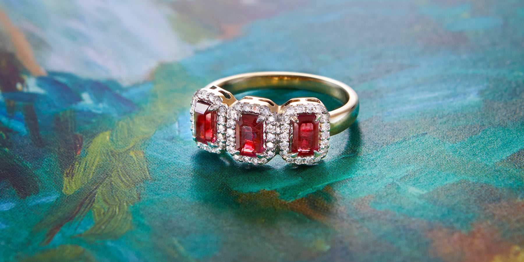 Yellow Gold Emerald Cut Rubies in the Garland ring from jewellery specialists Fenton 