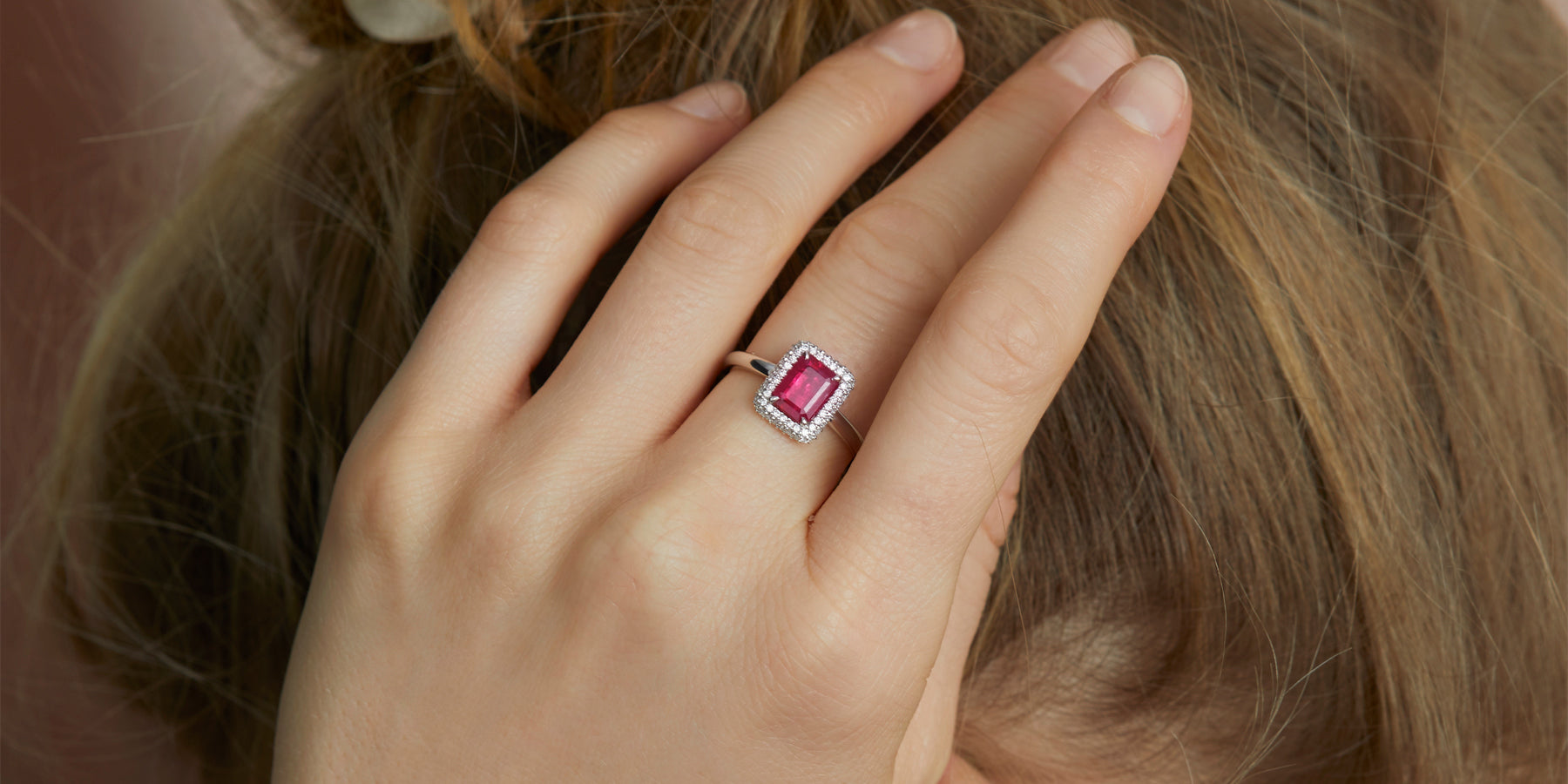 Woman wearing Ruby Platinum Halo ring from Fenton Fine Jewellery