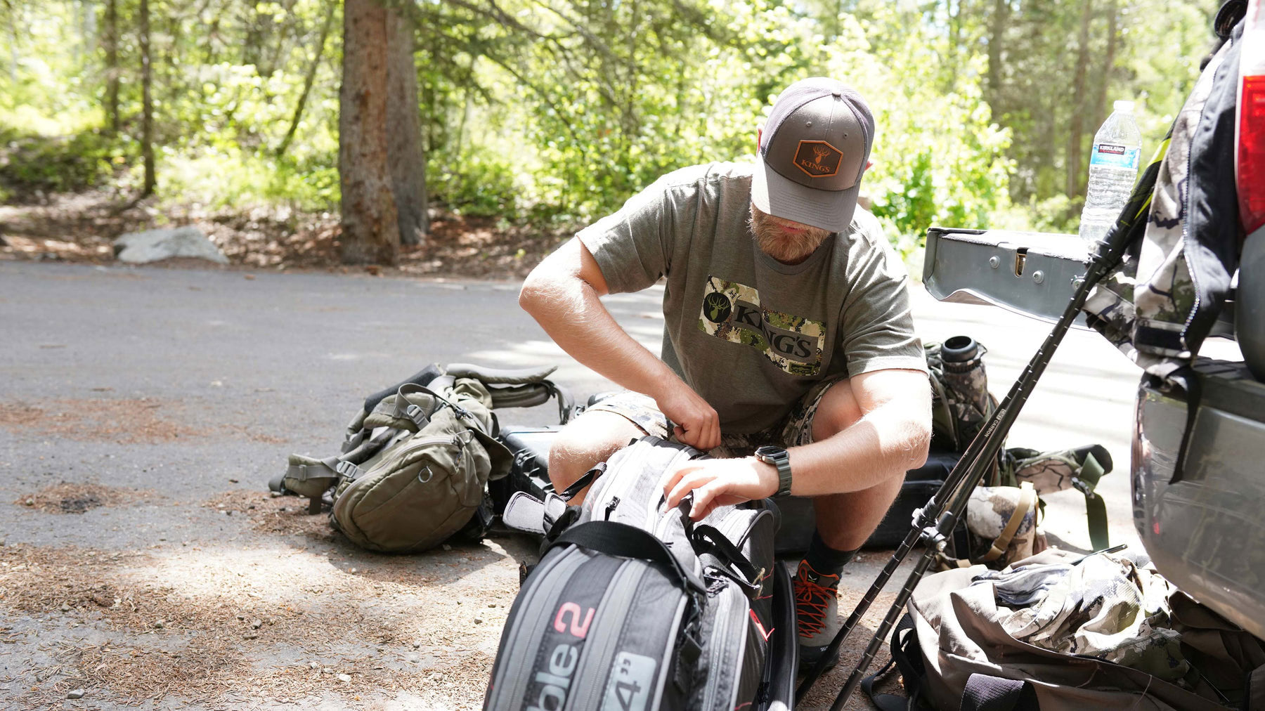 man wearing outdoor apparel packing hunting gear