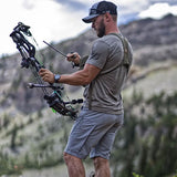 man wearing outdoor lifestyle clothing holding a bow