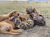 man with golden retriever lying on him