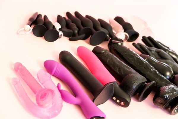 Pink and Black Sex Toys in the Pink Background