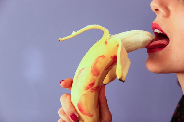 woman licking a banana