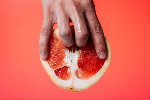 fingers inside grapefruit