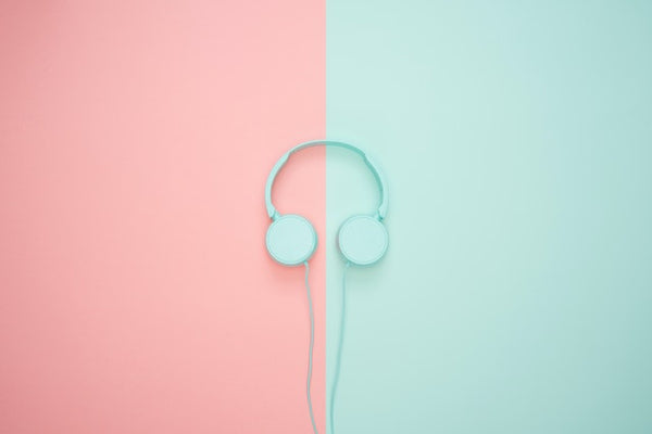 headphones on pink and teal background