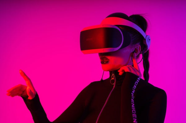 woman presenting person wearing vr headset