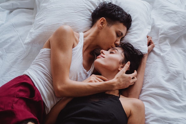 two women lying in bed
