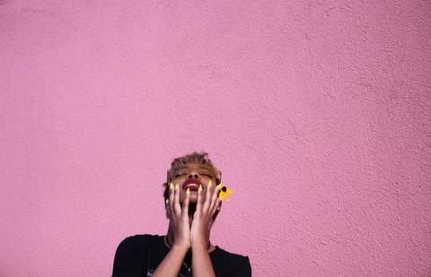 Woman in front of pink background