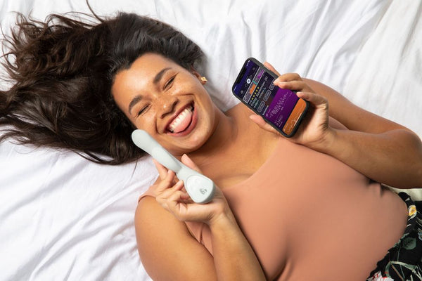 woman holding grey lioness and lioness app on a bed