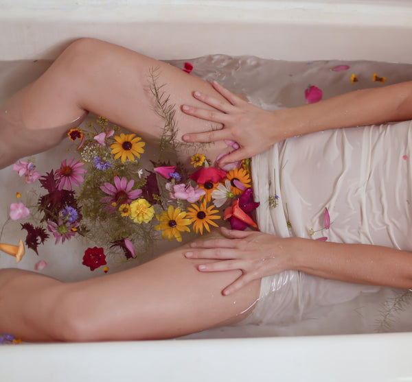 Woman in bath tub with flowers