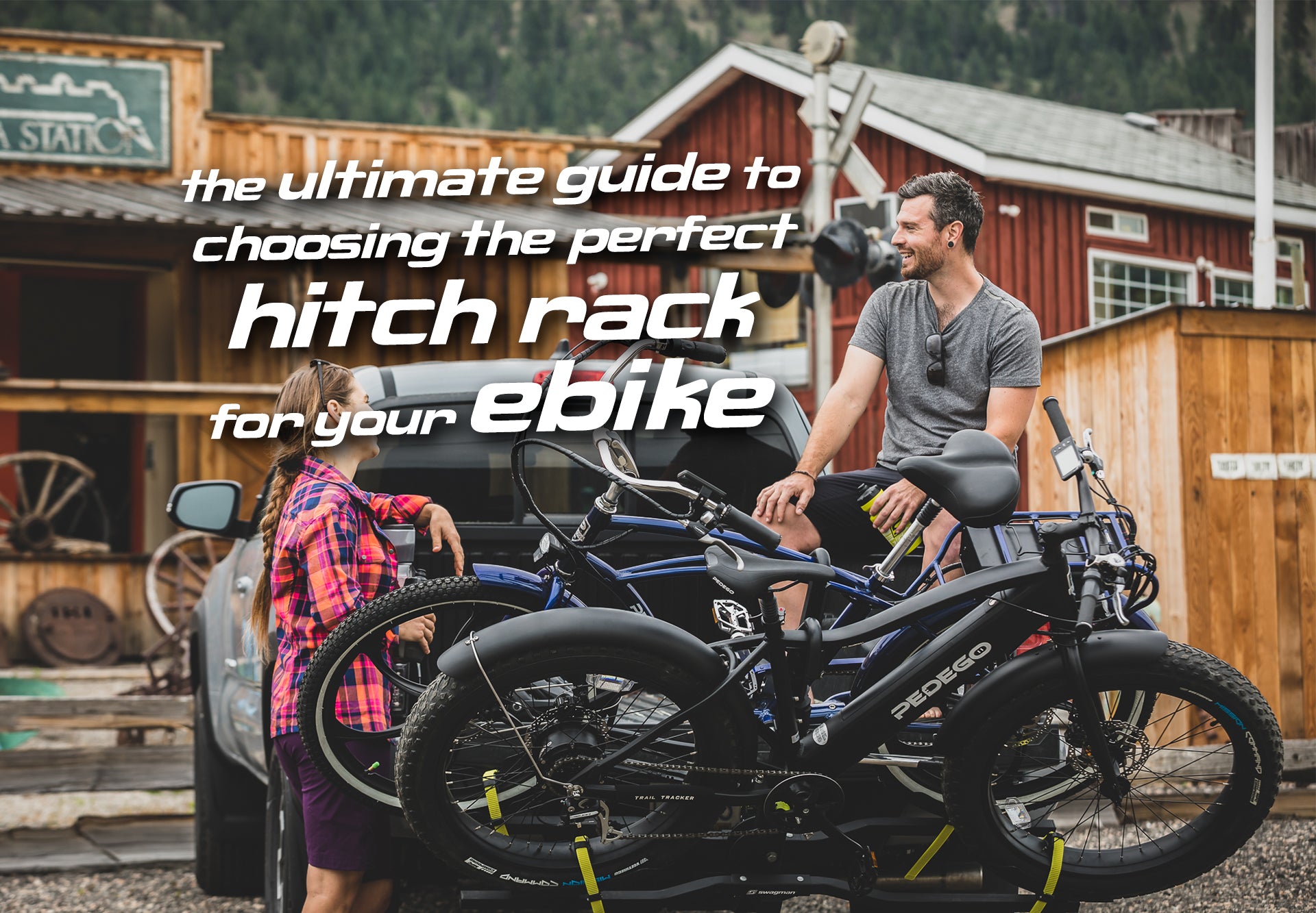 Swagman ebike-approved hitch mount bike rack on the back of a pickup truck with 2 ebikes mounted and two riders sitting on the tailgate chatting