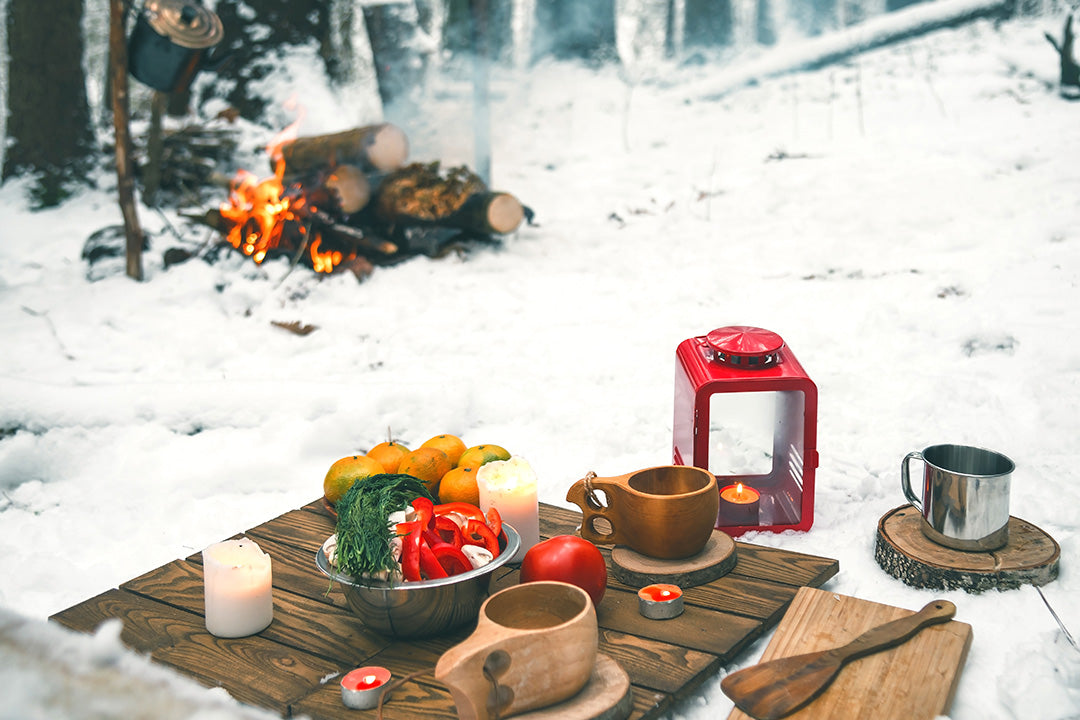 A winter picnic set up in the snow.
