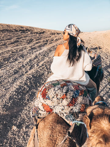 Ra'eesa riding camels in Morocco 