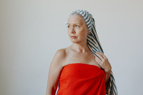 Woman wearing the Waffle Weave and Stripe Turkish Towels