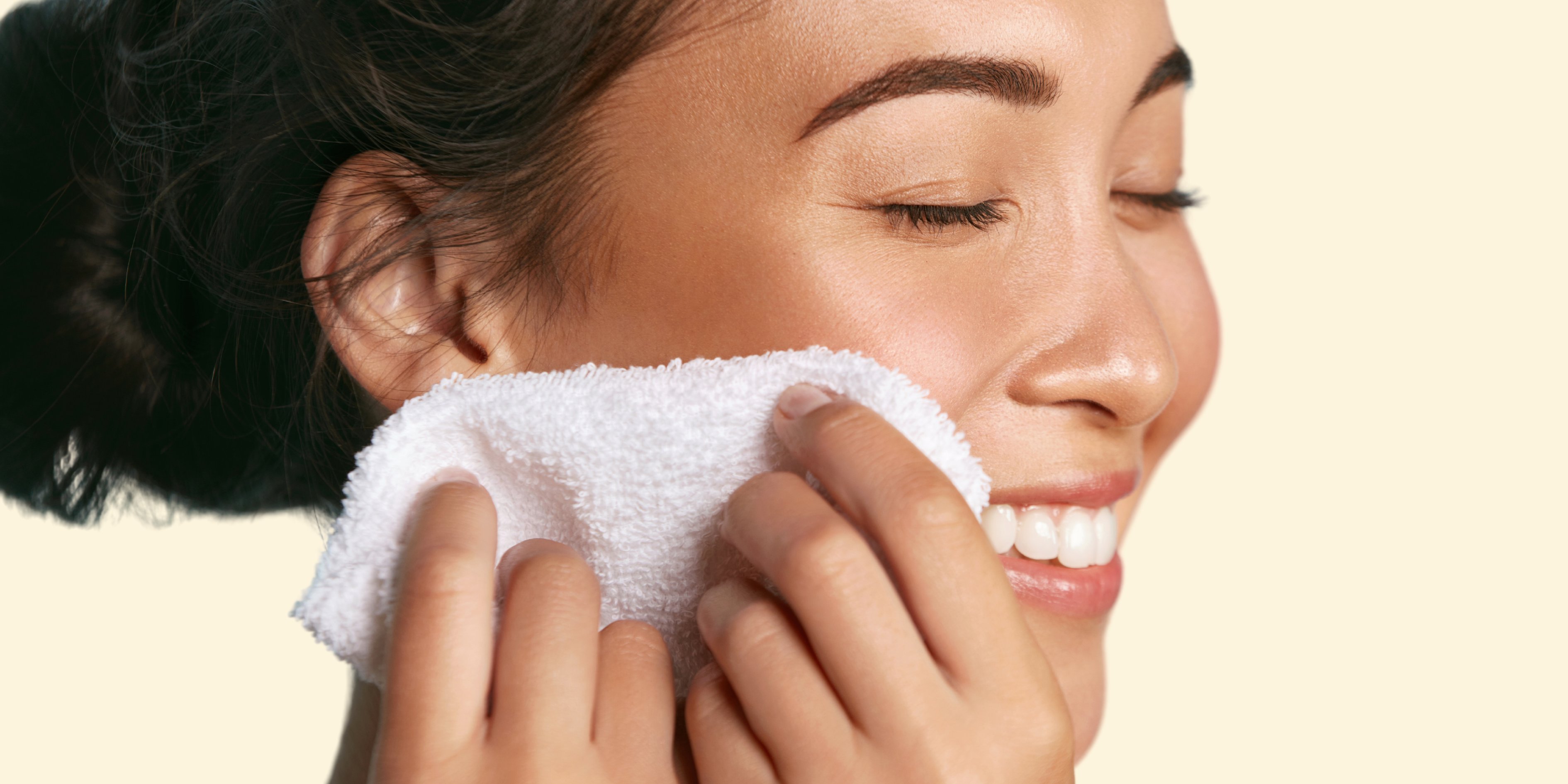 Woman gently patting her skin dry after cleansing with a cosmeceutical cleanser to sweep away impurities, excess oil and makeup.