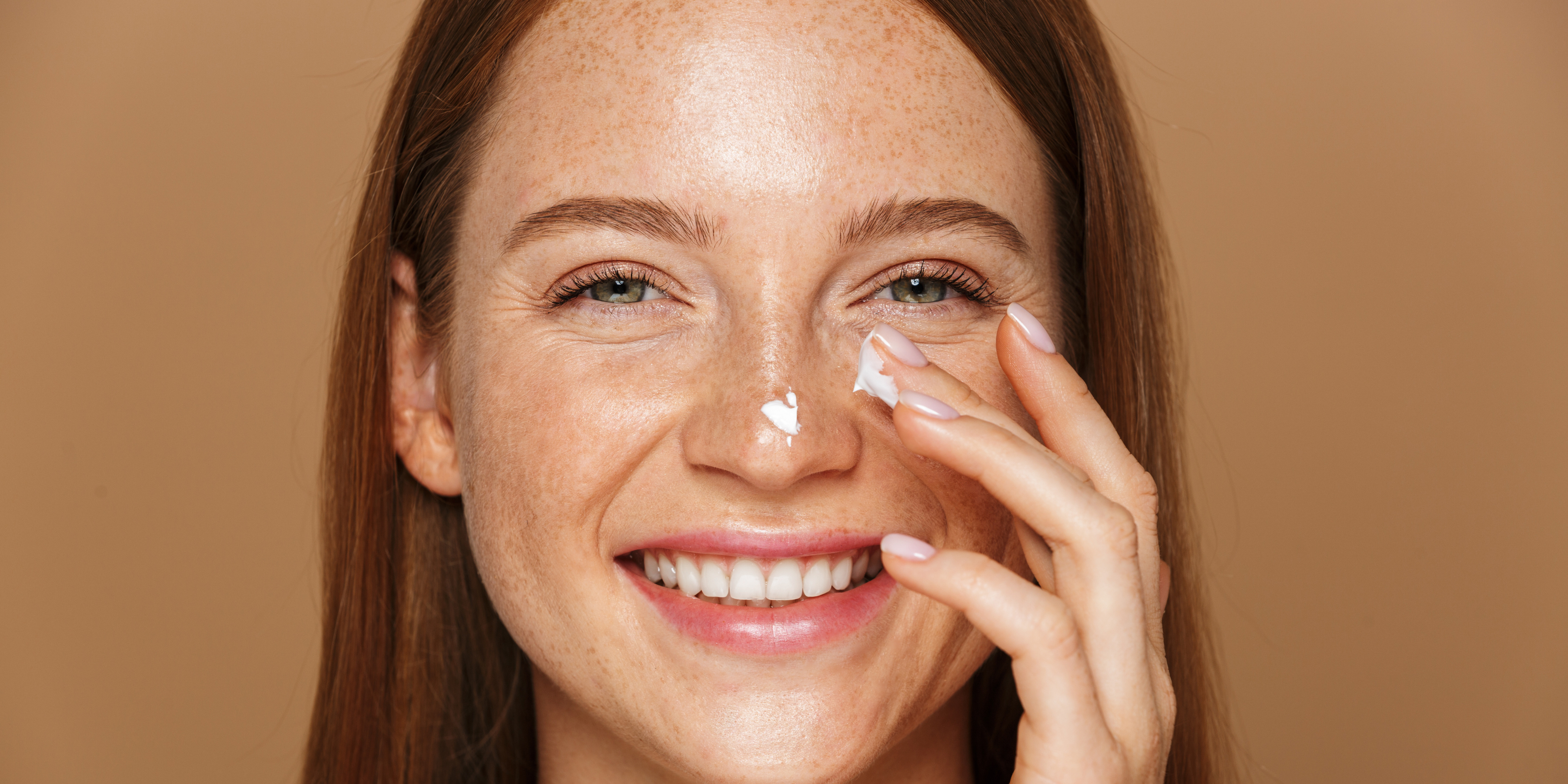 Woman applying a soothing and healing moisturiser to her skin 